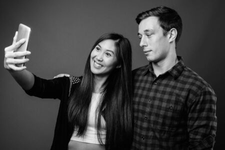 Portrait of young multi ethnic couple together in black and whiteの写真素材