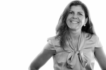 Studio shot of mature happy woman smiling