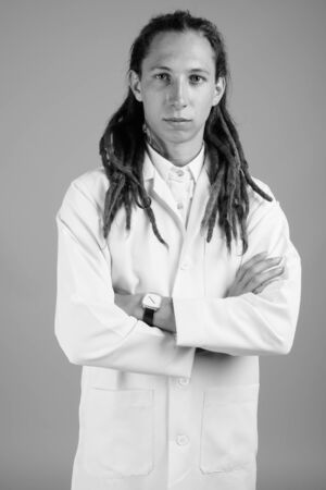 Young man doctor with dreadlocks in black and whiteの写真素材