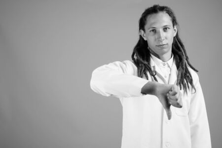 Young man doctor with dreadlocks in black and whiteの写真素材