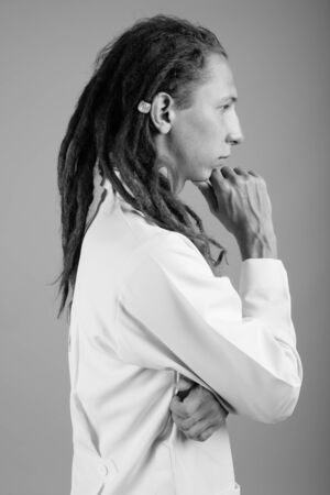 Young man doctor with dreadlocks in black and whiteの写真素材