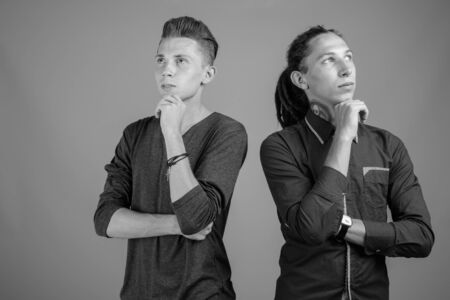 Young man with dreadlocks and young man together in black and whiteの写真素材