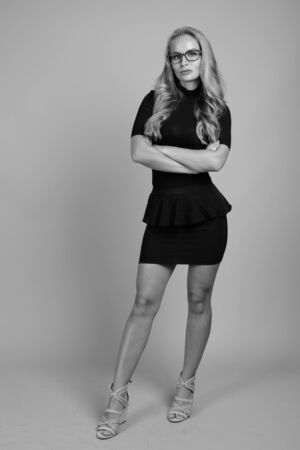 Young beautiful businesswoman with eyeglasses in black and whiteの写真素材