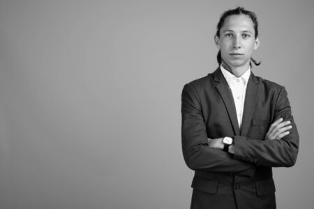 Young businessman with dreadlocks wearing suit in black and whiteの写真素材