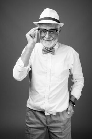 Handsome bearded senior tourist man in black and whiteの写真素材