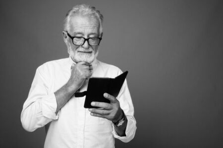 Handsome bearded senior man wearing stylish clothes in black and whiteの写真素材