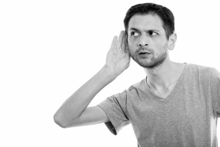 Studio shot of young man listening and thinking