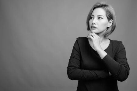 Portrait of beautiful Asian businesswoman in black and whiteの写真素材