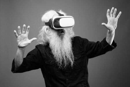 Senior man with long hair and beard in black and whiteの写真素材