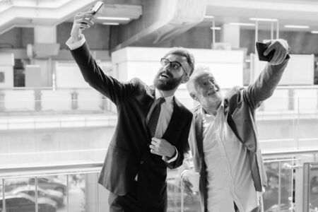 Multi ethnic bearded businessmen together around the city