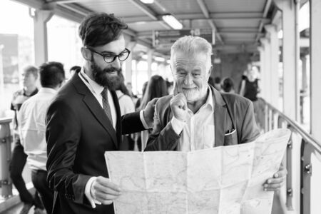 Multi ethnic bearded businessmen together around the city