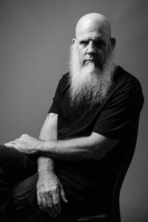 Mature bald man with long white beard in black and whiteの写真素材