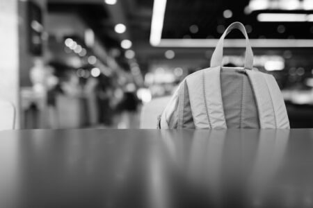 Close Up Portrait Of Backpack Inside The Mall Against View Of Luminous Lights In Black And Whiteの写真素材