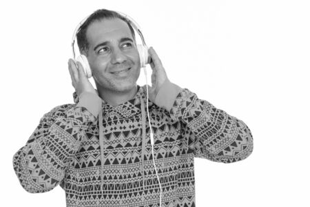 Mature happy Persian man listening to music