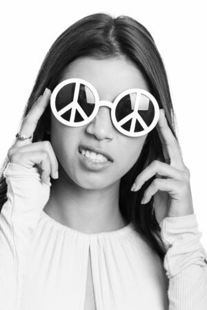 Face of young beautiful Brazilian woman wearing sunglasses with peace signの写真素材