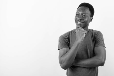 Young handsome African man against white background