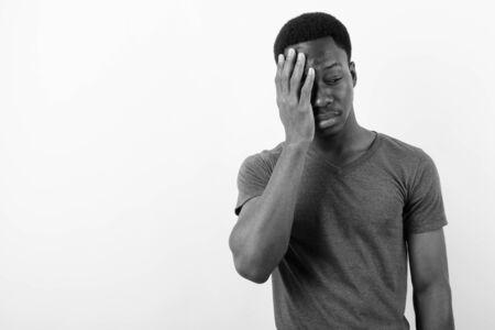 Young handsome African man against white backgroundの写真素材