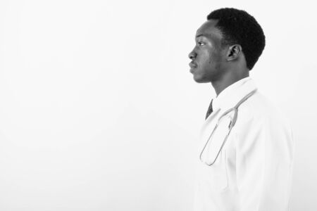 Young handsome African man doctor against white backgroundの写真素材