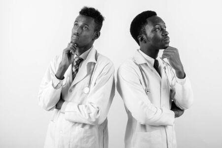 Two young African man doctors against white backgroundの写真素材