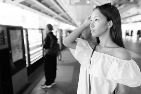 Young beautiful tourist woman exploring the city of Bangkokの写真素材