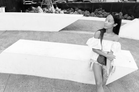 Young beautiful tourist woman exploring the city of Bangkokの写真素材