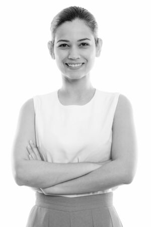 Studio shot of happy young beautiful woman smiling with arms crossedの写真素材