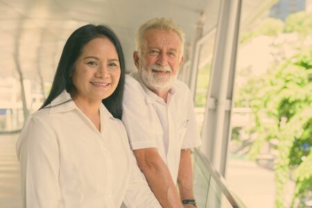 Mature multi-ethnic couple happy and in love while exploring the city of Bangkok, Thailandの写真素材