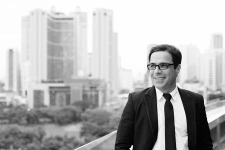 Handsome Persian businessman against view of the cityの写真素材