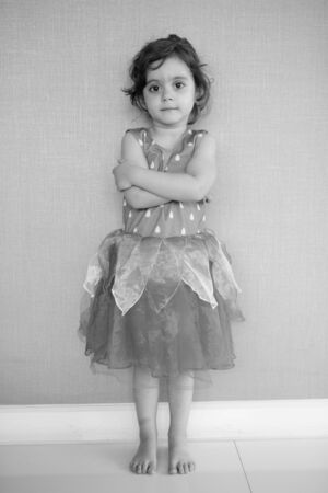 Young cute girl against concrete wall at homeの写真素材