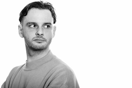 Studio shot of young man looking backの写真素材