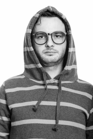 Face of young man wearing hoodie in black and whiteの写真素材