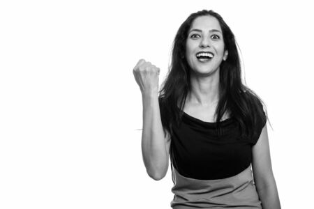Studio shot of happy Persian woman smiling looking motivatedの写真素材