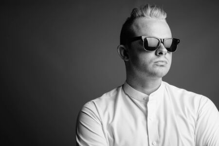 Portrait of businessman with Mohawk hairstyle and blond hairの写真素材