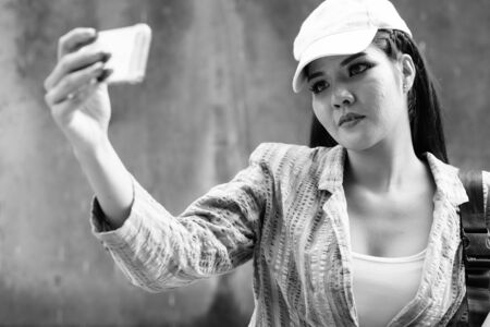 Young beautiful Asian tourist woman exploring the cityの写真素材