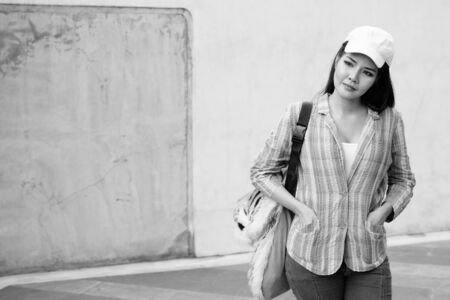 Young beautiful Asian tourist woman exploring the city