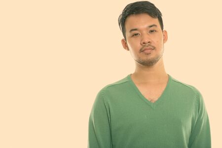 Studio shot of young Asian manの写真素材