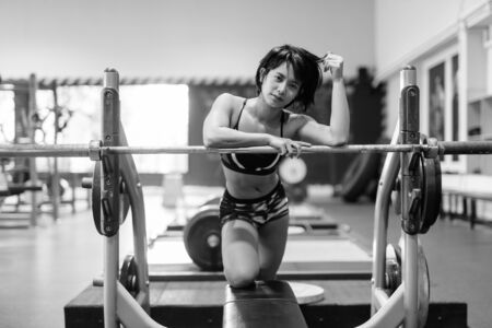 Young beautiful Asian woman working out at the gymの写真素材