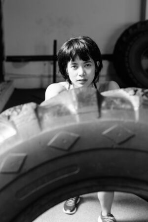 Young beautiful Asian woman working out at the gymの写真素材