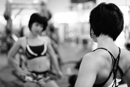 Young beautiful Asian woman working out at the gymの写真素材