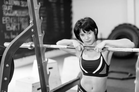 Young beautiful Asian woman working out at the gymの写真素材
