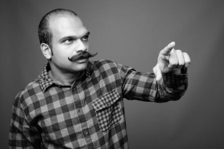 Indian man with mustache against gray backgroundの写真素材