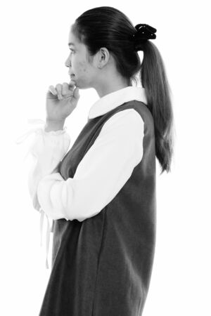 Profile view of young Asian woman thinkingの写真素材
