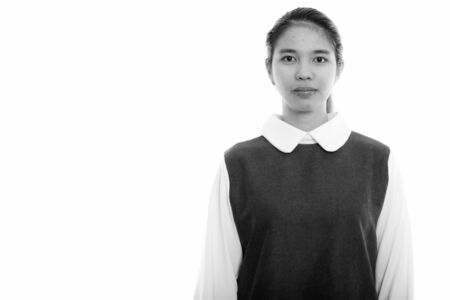 Studio shot of young Asian woman looking at camera