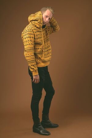 Studio shot of young handsome man against gray background in black and whiteの写真素材
