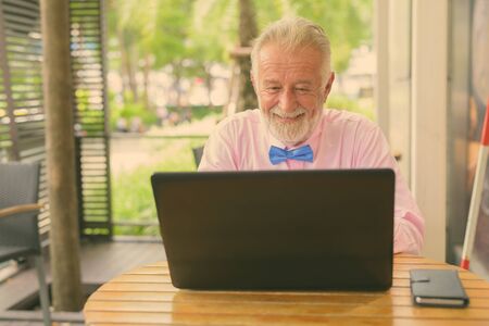 Handsome senior tourist man exploring the cityの写真素材