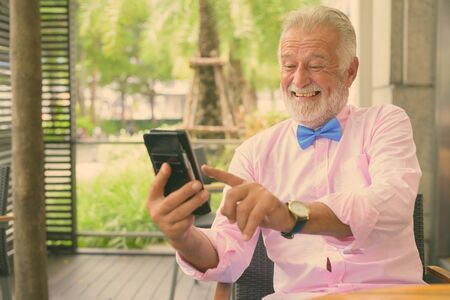 Handsome senior tourist man exploring the cityの写真素材