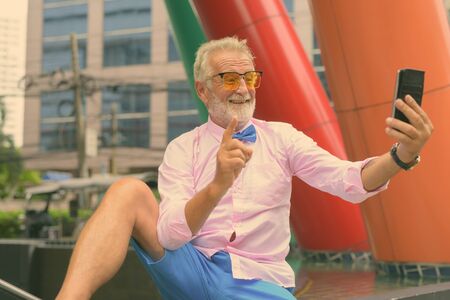 Handsome senior tourist man exploring the cityの写真素材