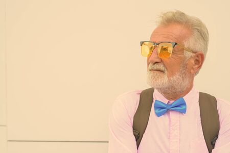 Handsome senior tourist man exploring the city