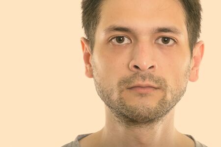 Studio shot close up of young man