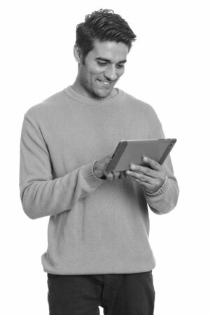 Young happy Persian man using digital tabletの写真素材